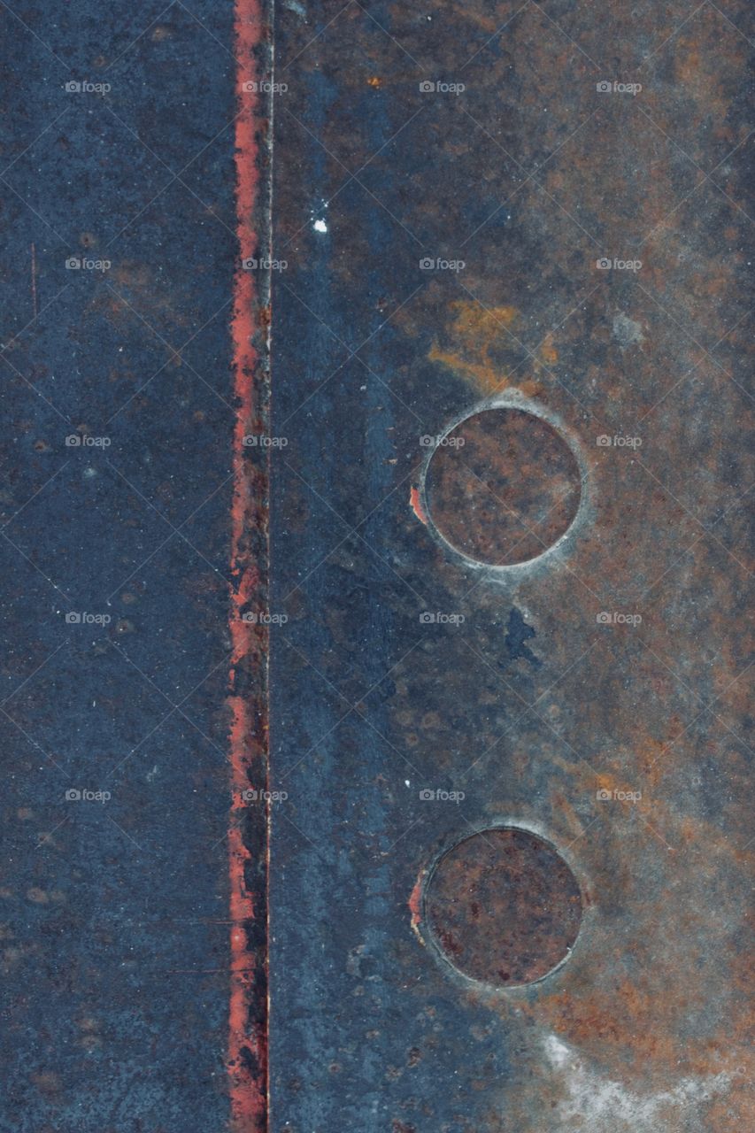 The various colors of paint and patina on steel with flat rivets