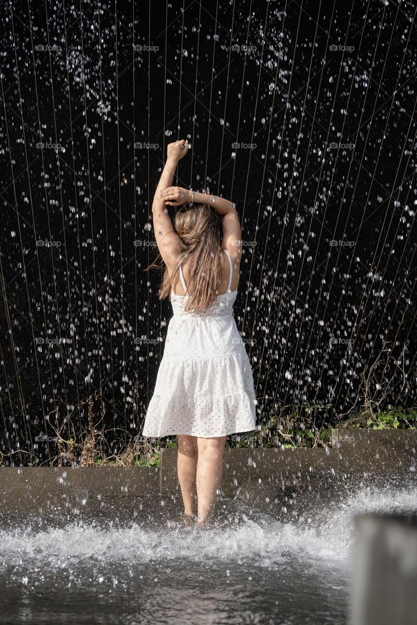 woman dancing in fountain