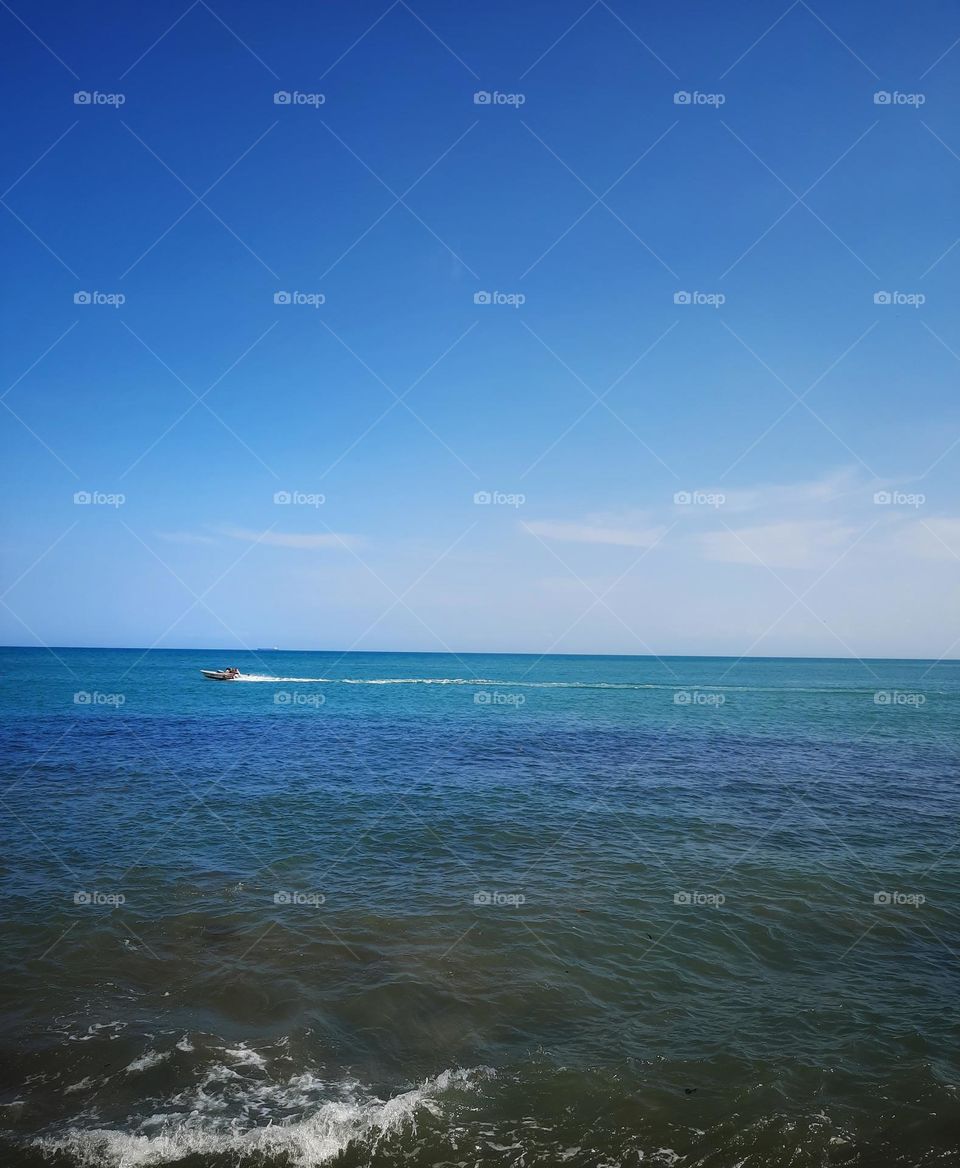 boat through the blue sea