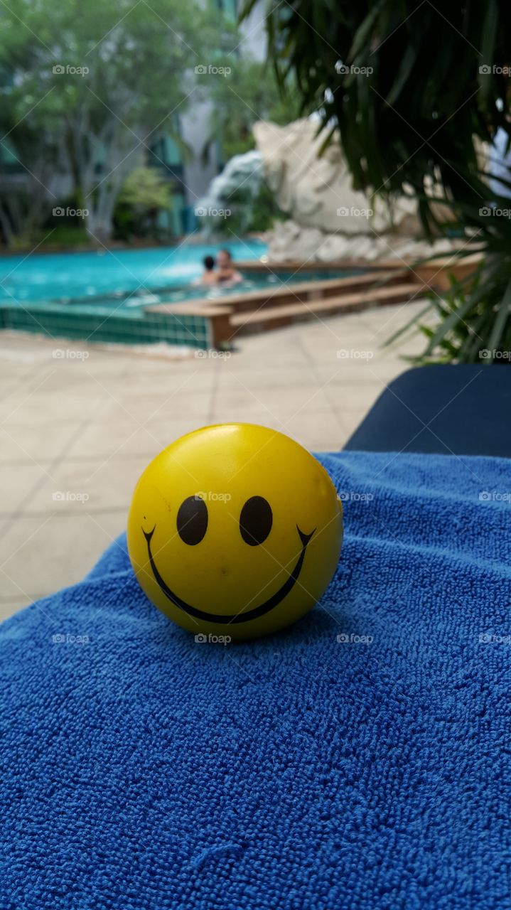 Smiley holidays. Smiley ball at the pool