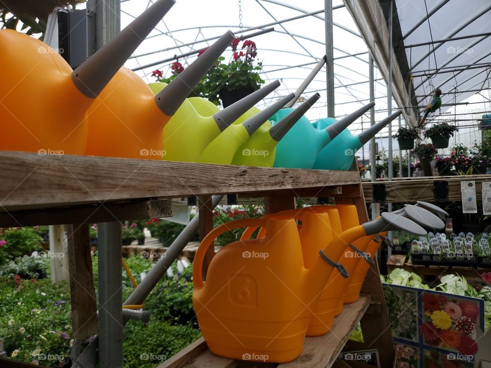 Colorful watering cans at the garden center.