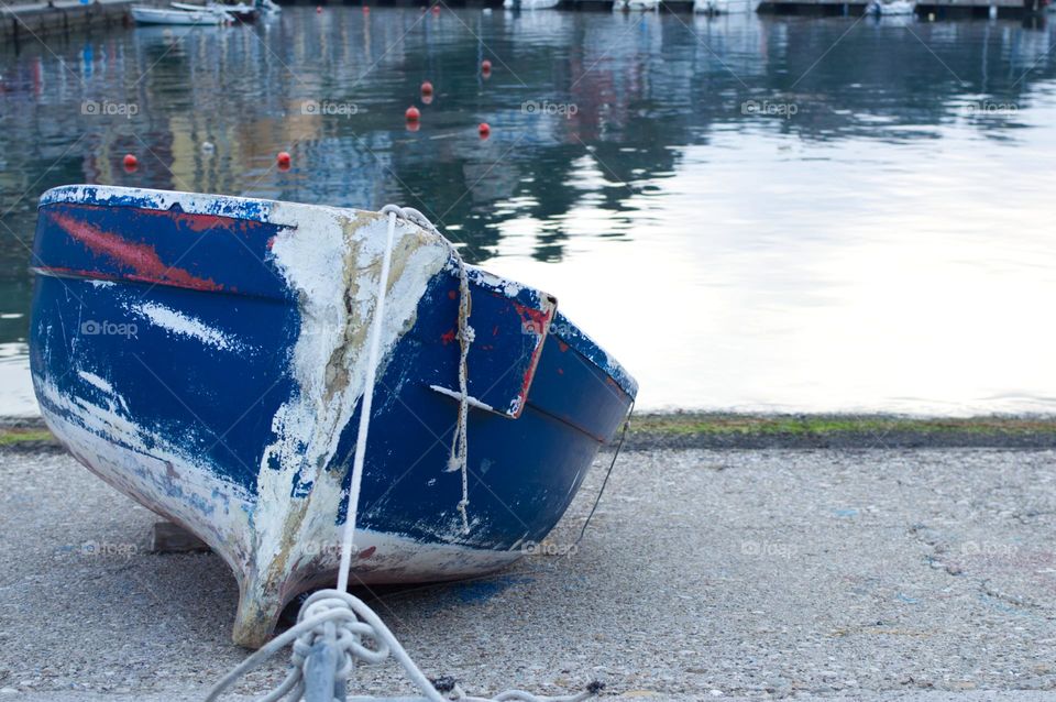 ancient boat moored to the shore