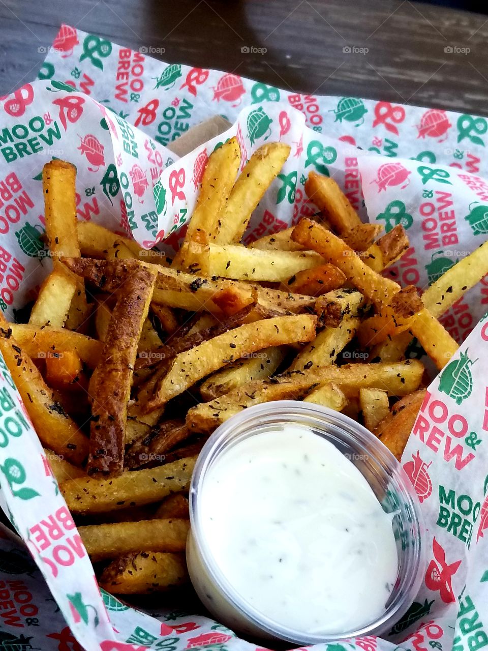 Perfectly golden crispy gourmet French fries sprinkled with rosemary spice, truffle oil and complimented by a small cup of creamy ranch dressing to dip them in.