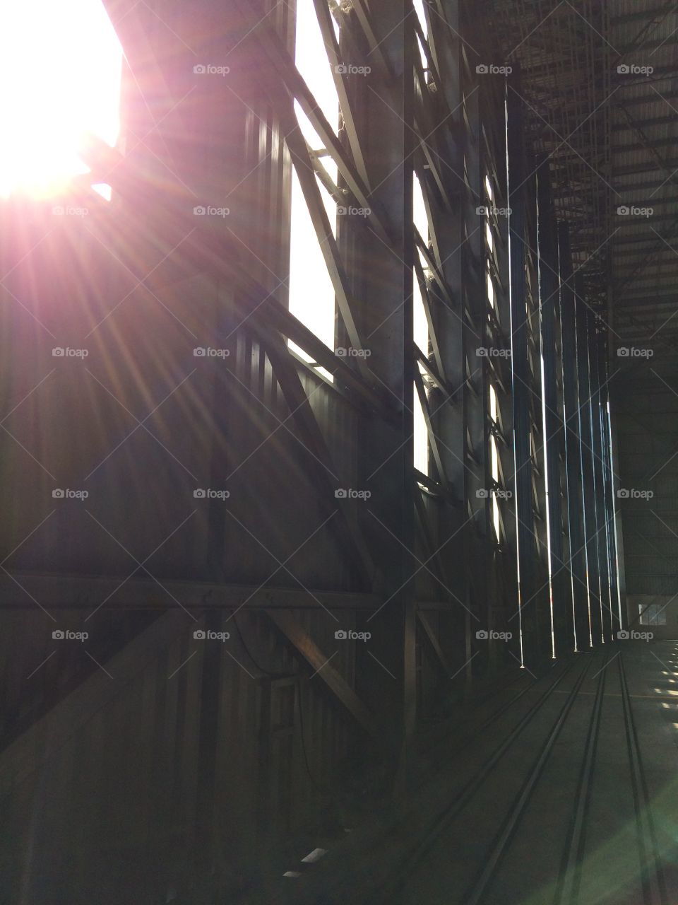 Sunlight sneaking in through hangar doors. 