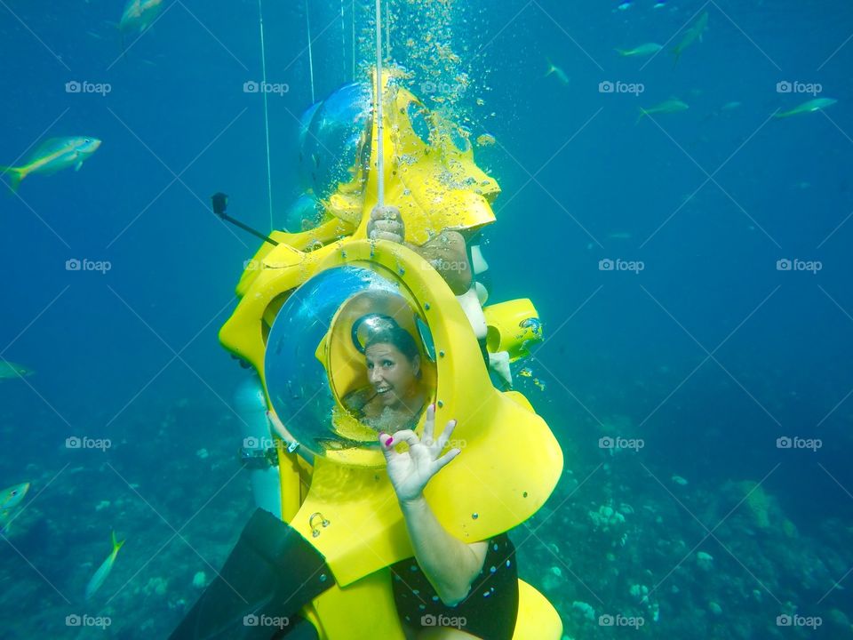 Woman showing ok sign under sea