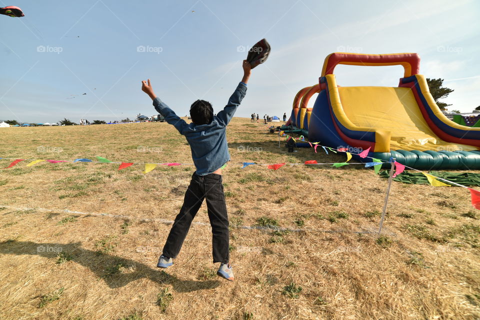 Cheerful boy happy to see bouncy slide.