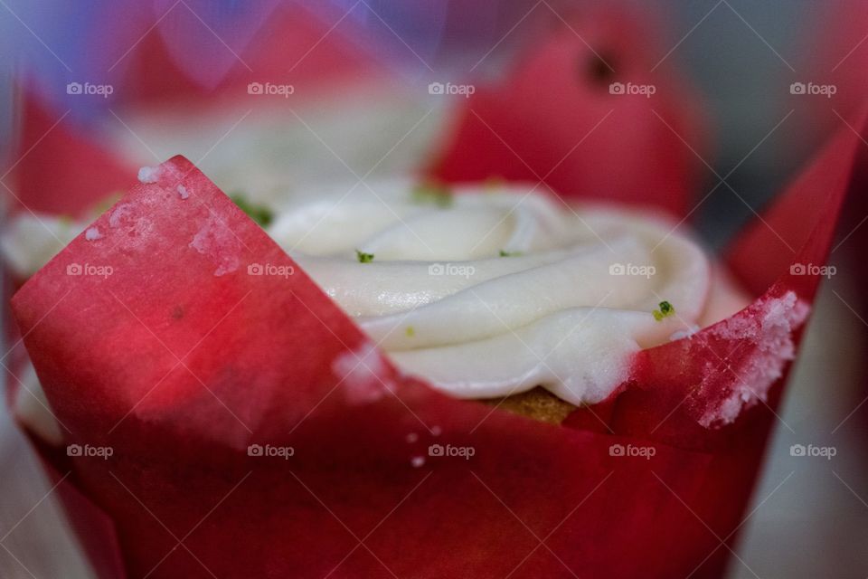Cupcake with white frosting in red wrappers 