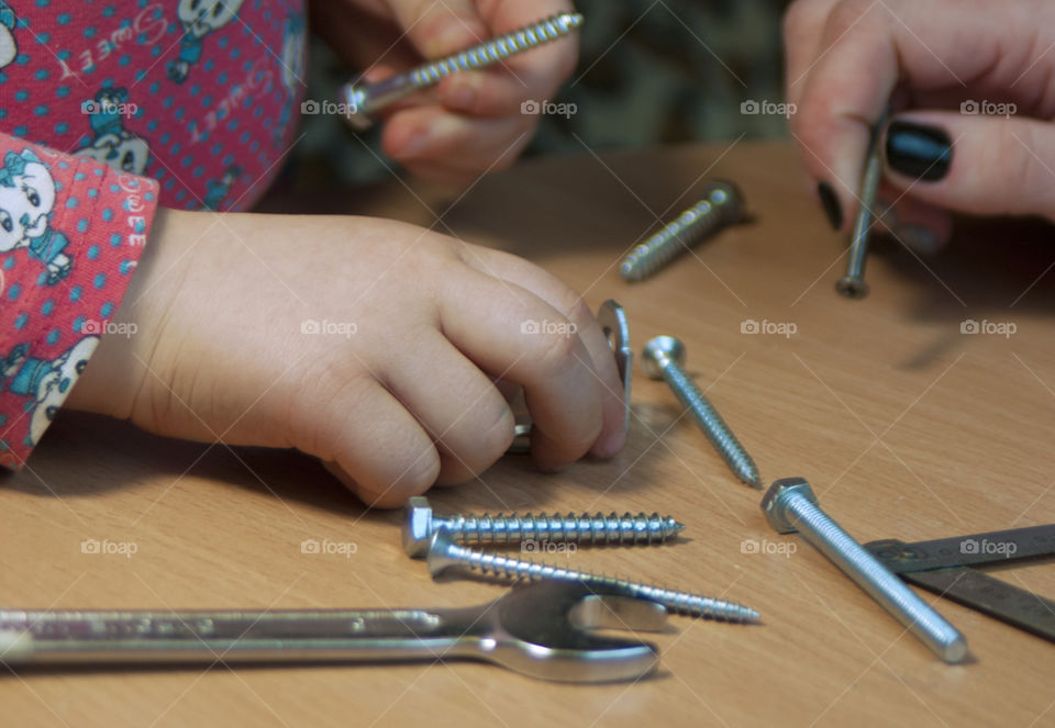 little girl holding tools