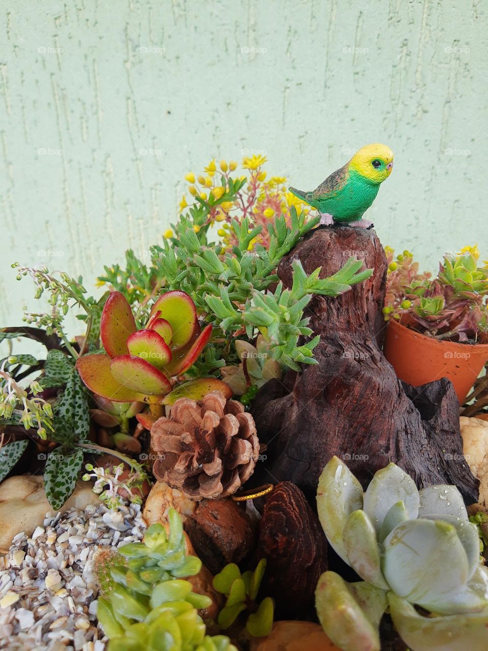 a small bird on a tropical plant's arrangment