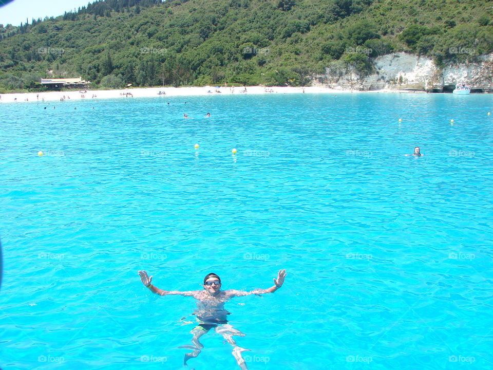 Man floating in water in sea