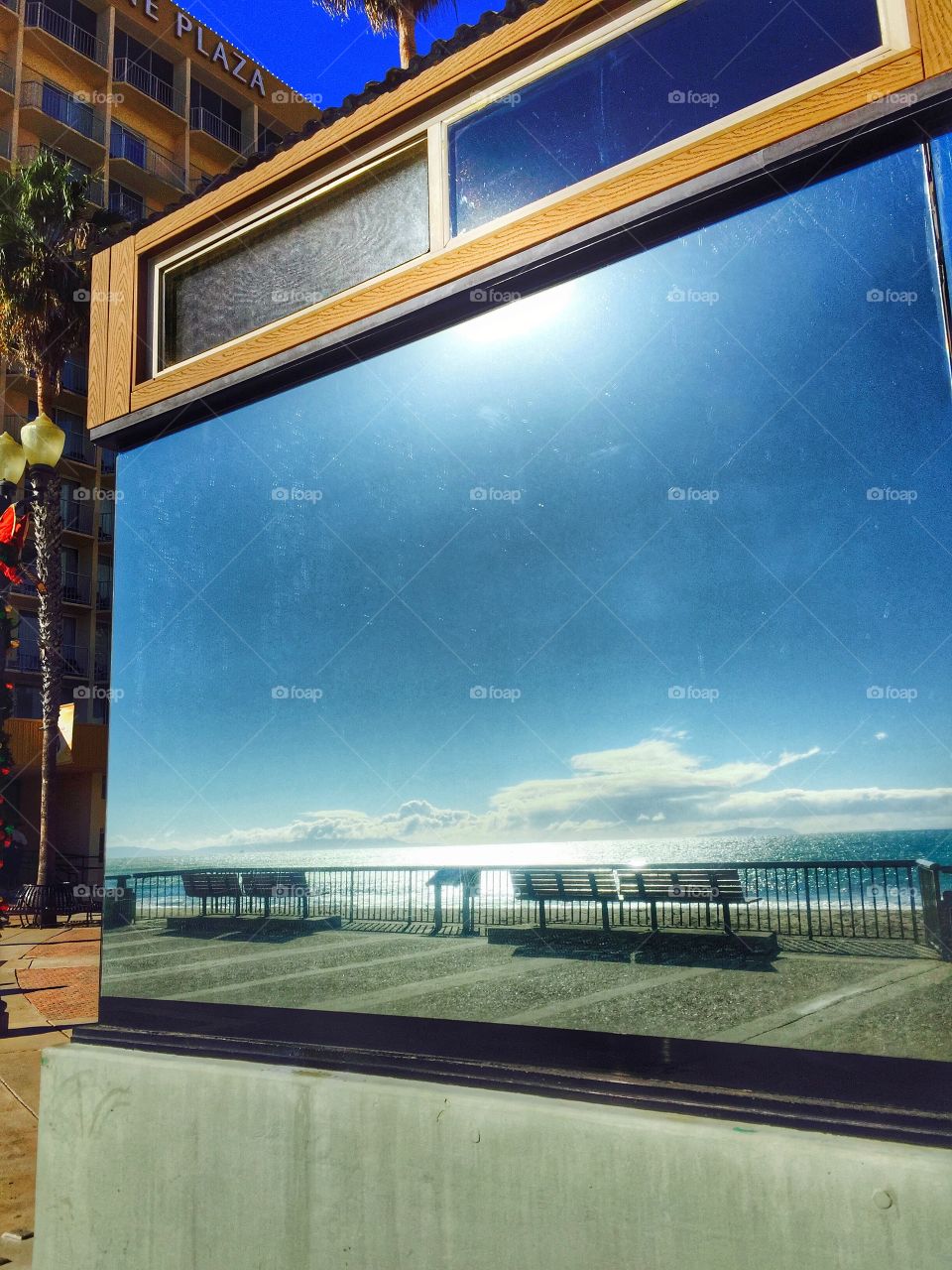  Picture Window  Reflections. Reflections of the blue sky and ocean view as seen from a big glass window at a California, United States beach.