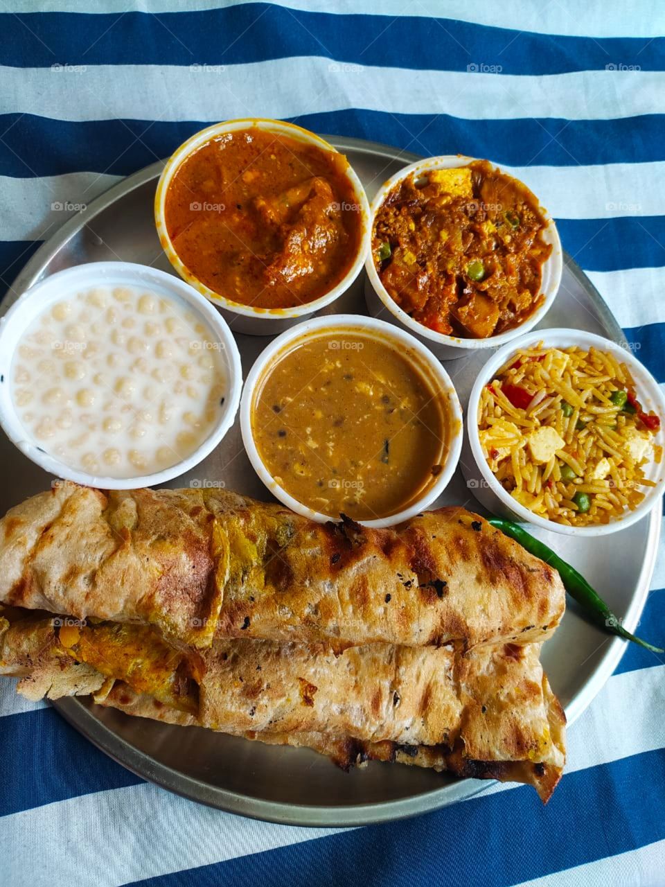 Thali (meaning "plate") is a round platter used to serve food in the Indian subcontinent and Southeast Asia. Thali is also used to refer to an Indian-style meal made up of a selection of various dishes which are served on a platter.