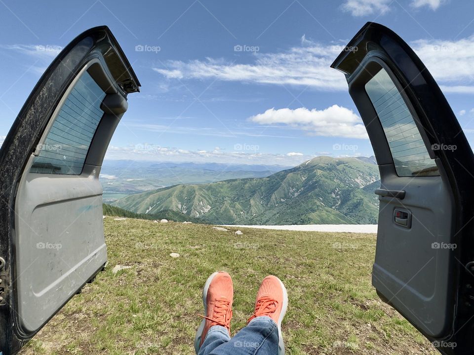 admire the mountains through the open car doors