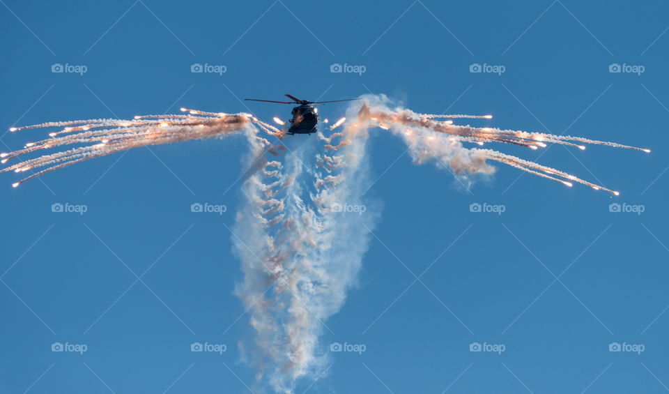 Helsinki, Finland - 9 June 2017: Finnish Army NH90 helicopter shooting out flares at the Kaivopuisto Air Show in Helsinki, Finland on 9 June 2017.
