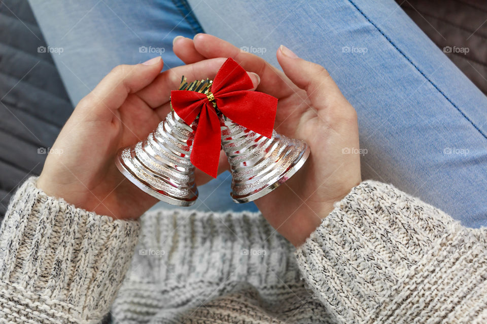 girl  is holding a christmas bell