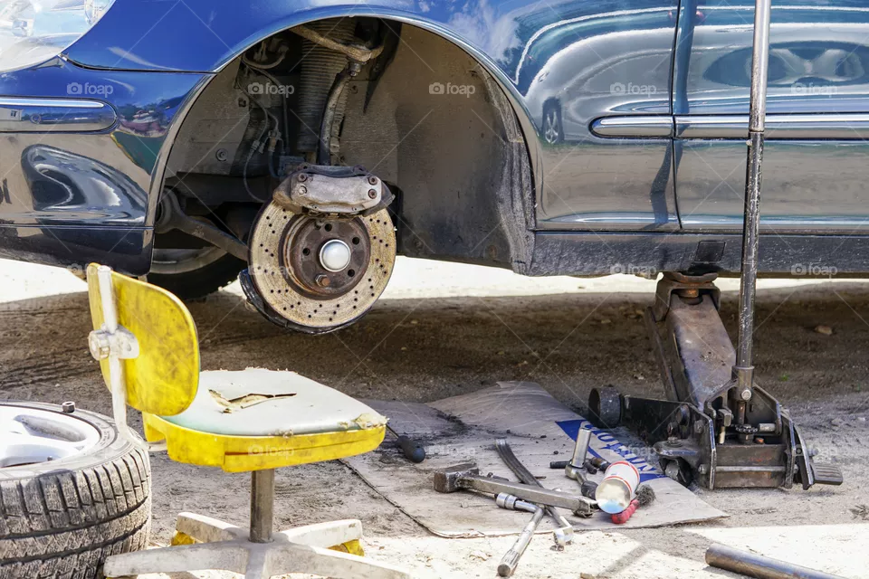 repair of a car brake outdoors