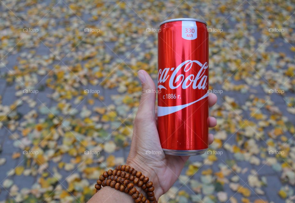 coca cola in the hand fall beautiful texture background