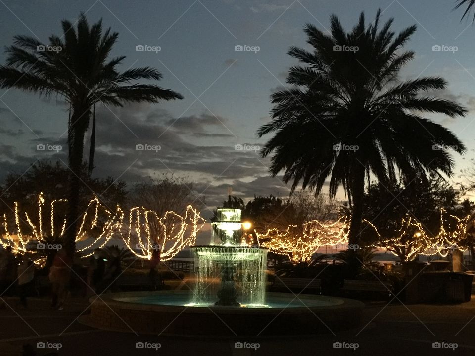 A lighted fountain on the waterfront.