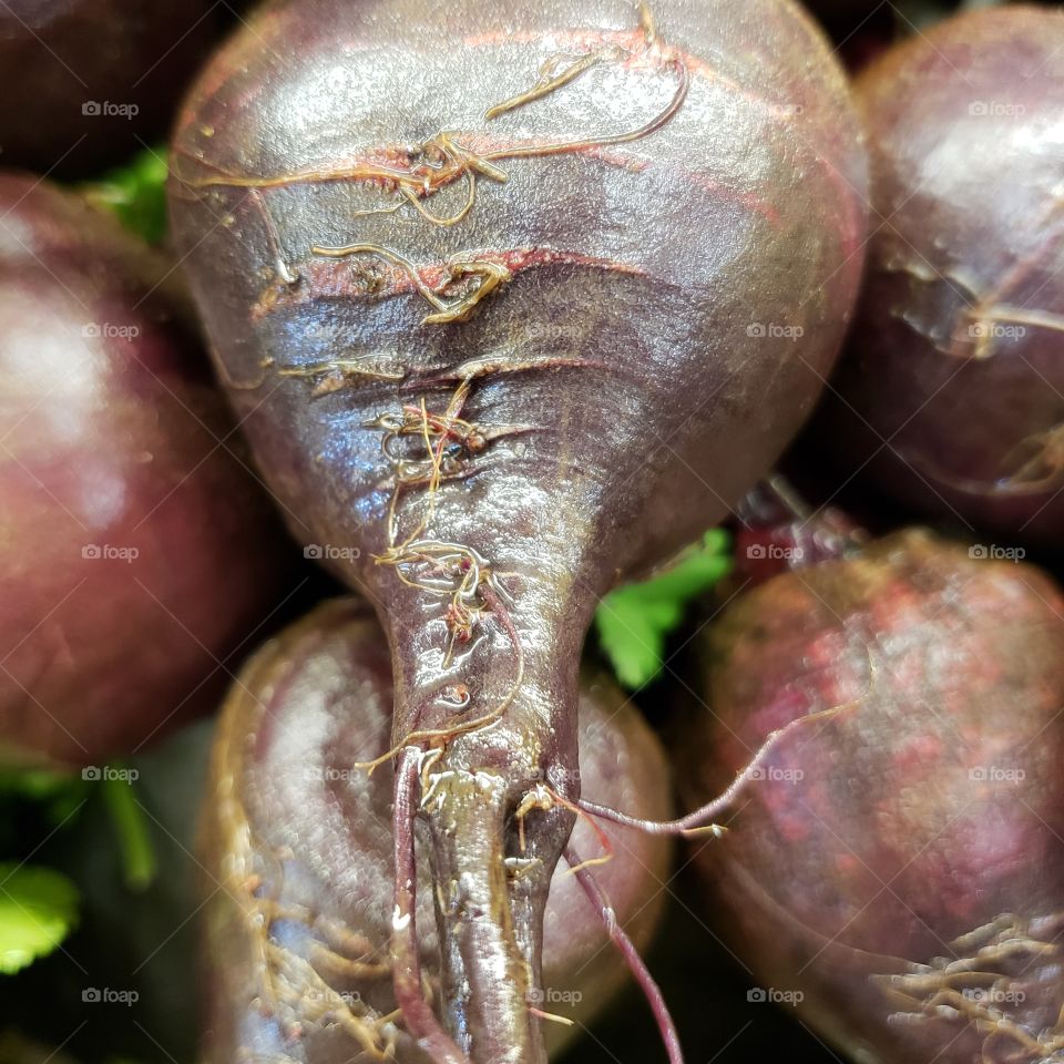 Fine details of texture on big red beats close up at the market