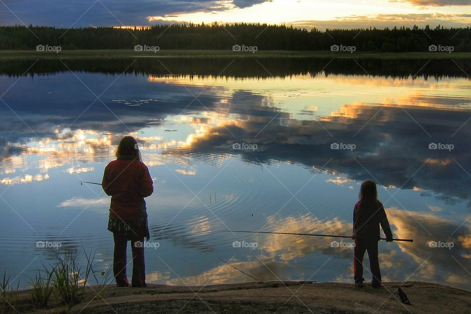 Mother and child fishing at the lake