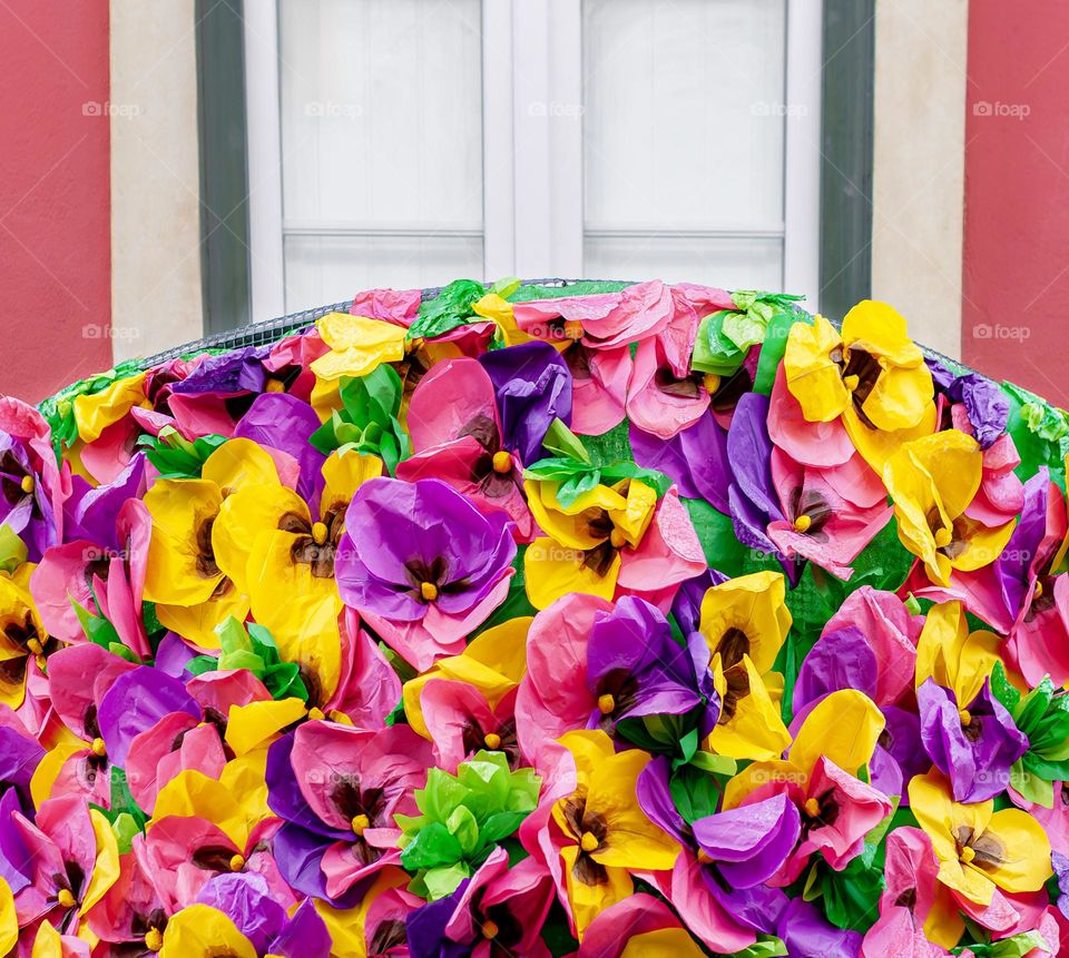 Balcony decorated with colourful paper flowers for Festas Dos Tabuleiros in Portugal