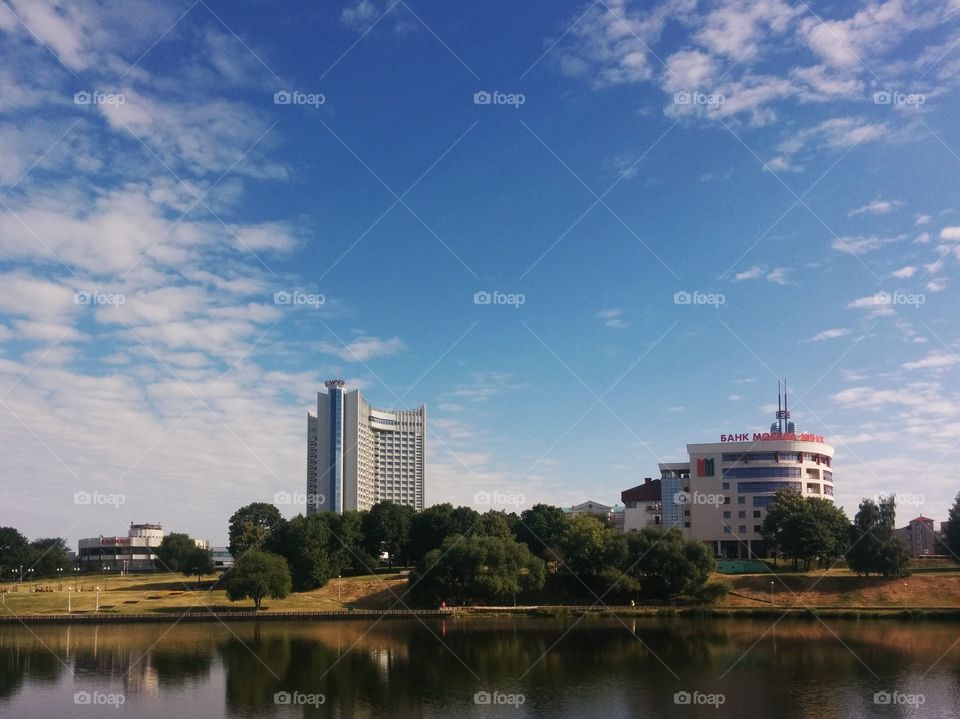 Hotel "Belarus".  Minsk. Minsk, (Belarus). View of the hotel "Belarus" and the bank "Moscow-Minsk". Embankment Svisloch. 2015