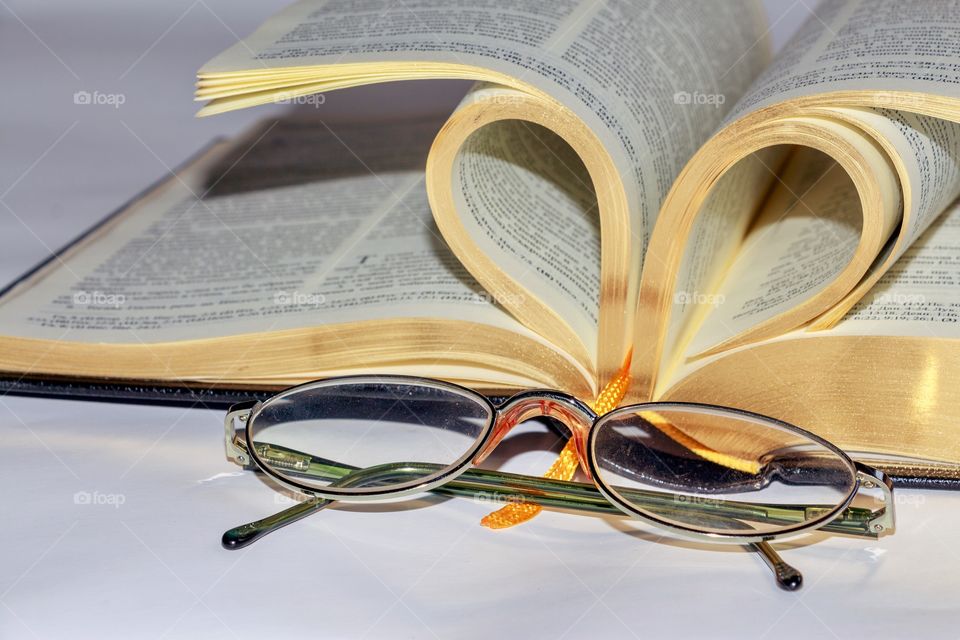 A book with golden pages and glasses
