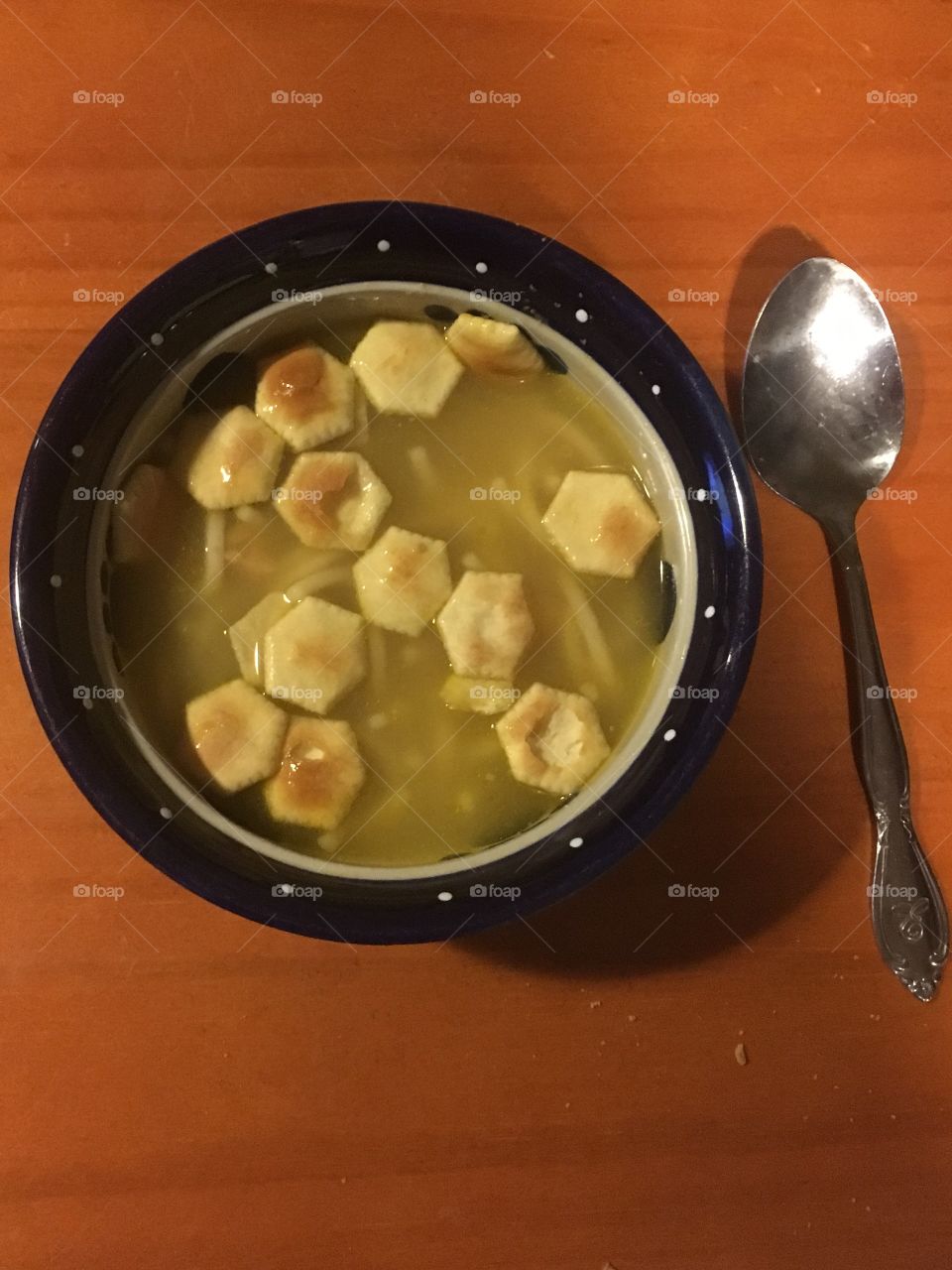 A warm and delicious bowl of soup with a handful of crackers to complete the look. 