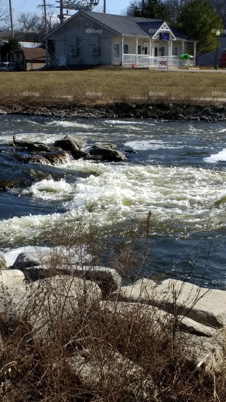 River rapids, churning waters in the Fox River, Yorkville, IL.