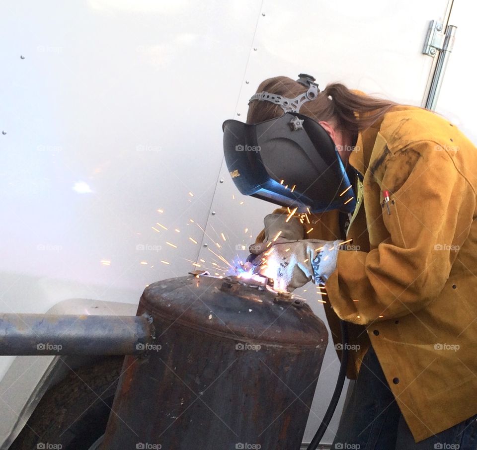 Weld. A man cutting welding and metal working