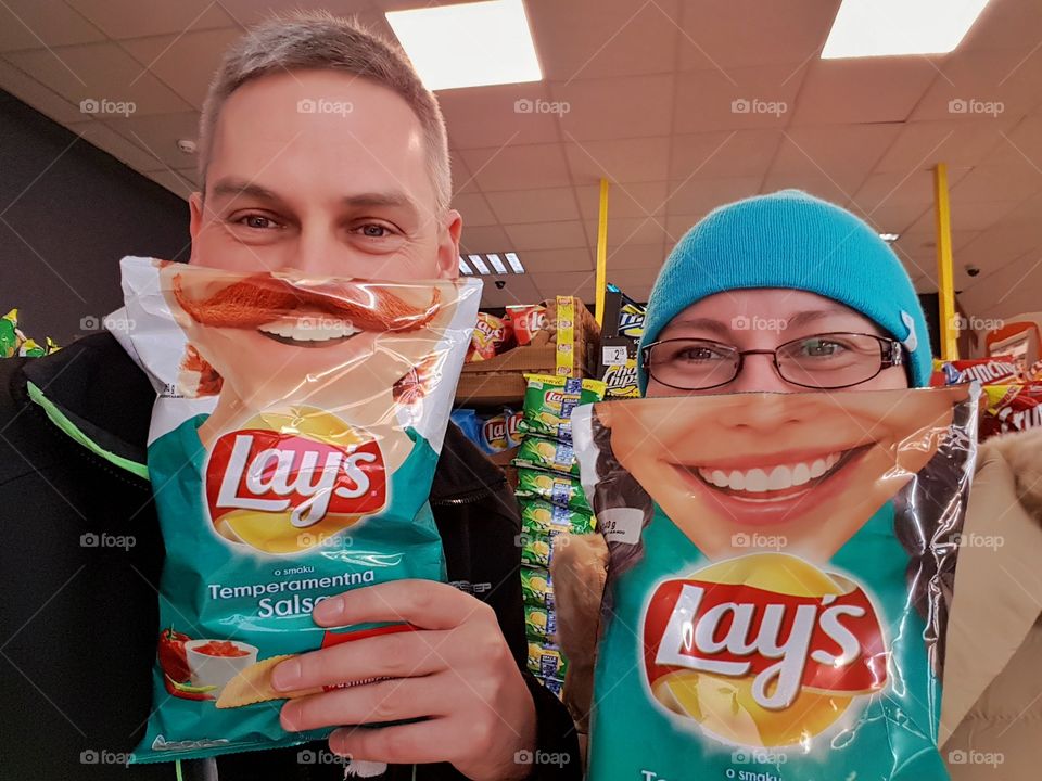 Close-up of man and girl holding wafer packet