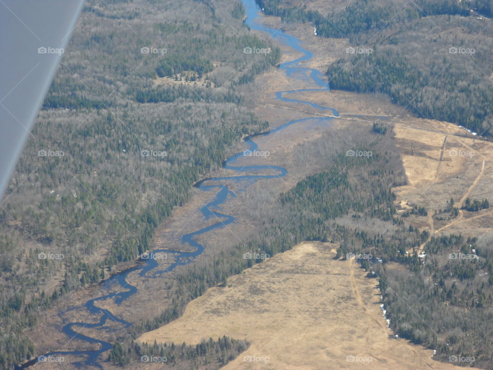 Curvy stream from above. pics from inside small plane