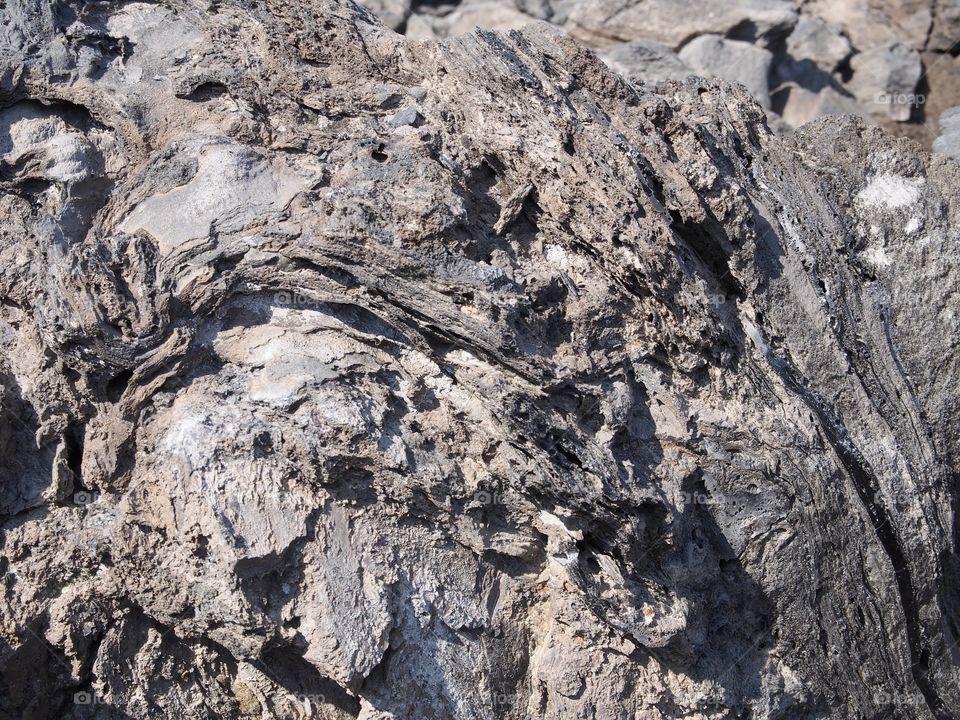 Beautiful details and texture of hardened lava rock in Central Oregon at the Big Obsidian Flow on a sunny fall day. 