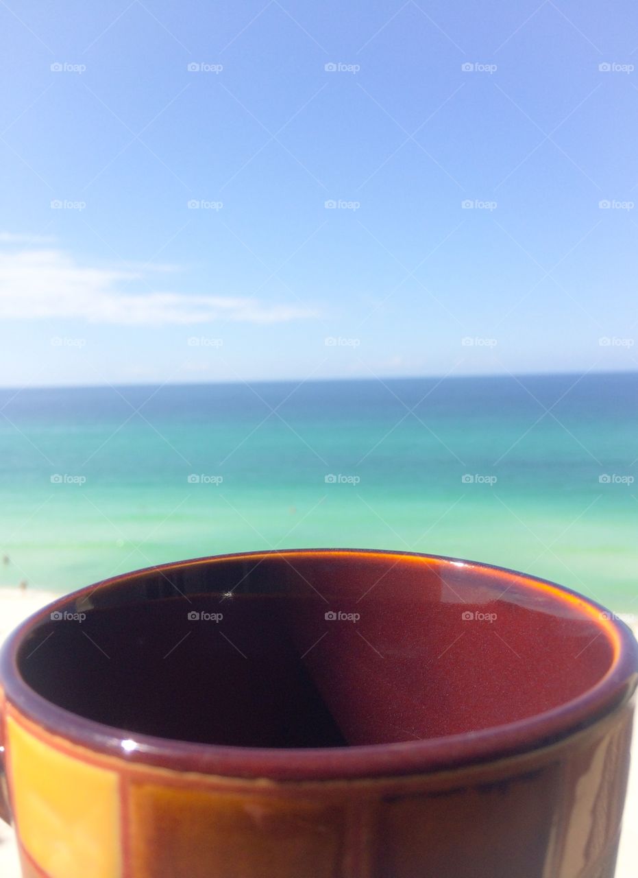 Coffee at sunrise . Coffee in hand overlooking the ocean 
