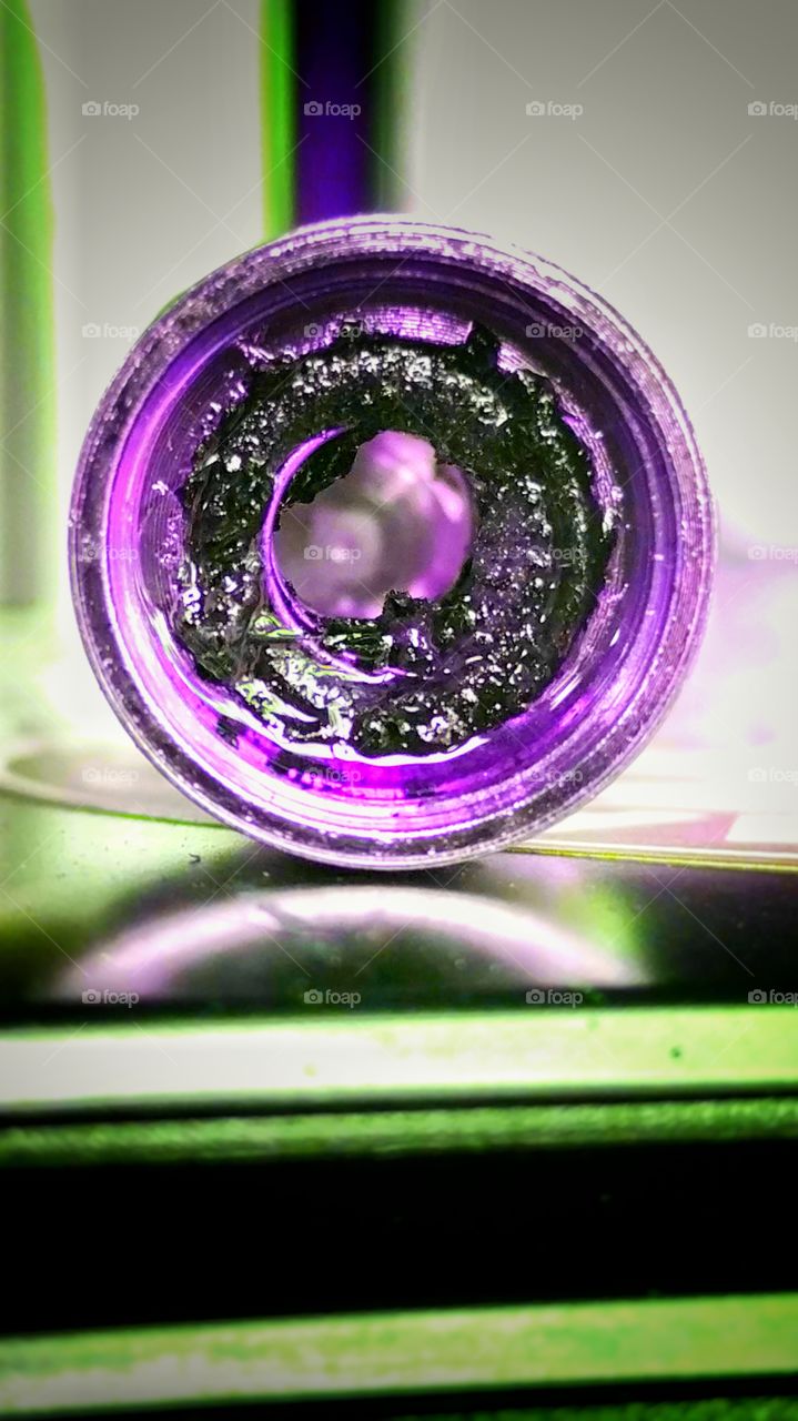 "Dirty Coil" This coil is used in an ecig device. This is what happens when your cotton is burnt and hasn't been changed in over a month! UV lighting was used to highlight the old nicotine left inside!