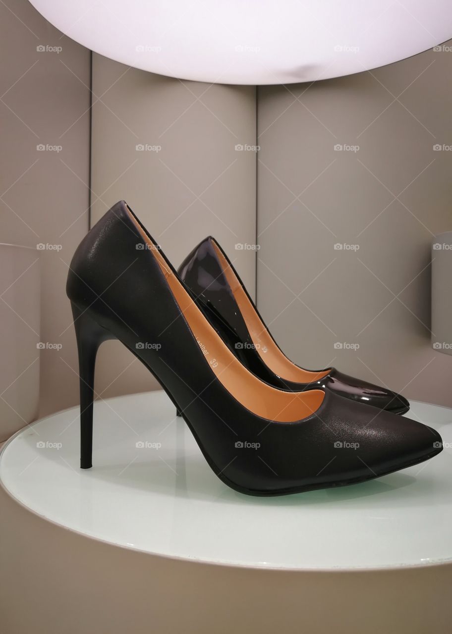 Stylish black leather high heels on retro display