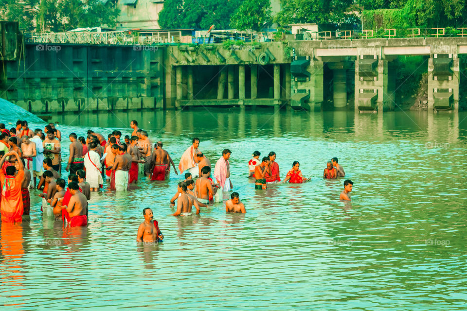 HARIDWAR, INDIA - JANUARY 14, 2016: Devotees taking holy dip at Har Ki Pauri on river Ganga on the first bath of Ardh Kumbh fair. People took a dip in holy Ganges on the occasion of Makar Sankranti