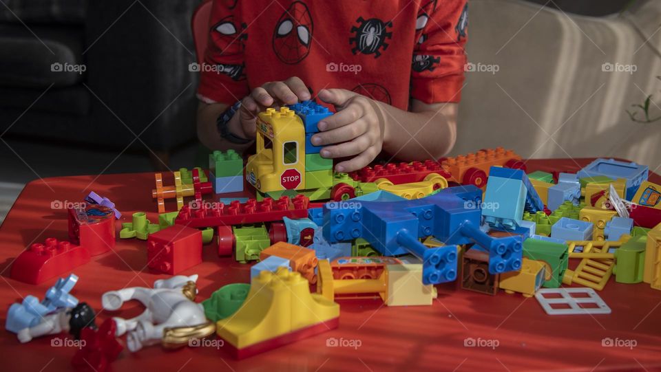 6 years old boy playing with Lego