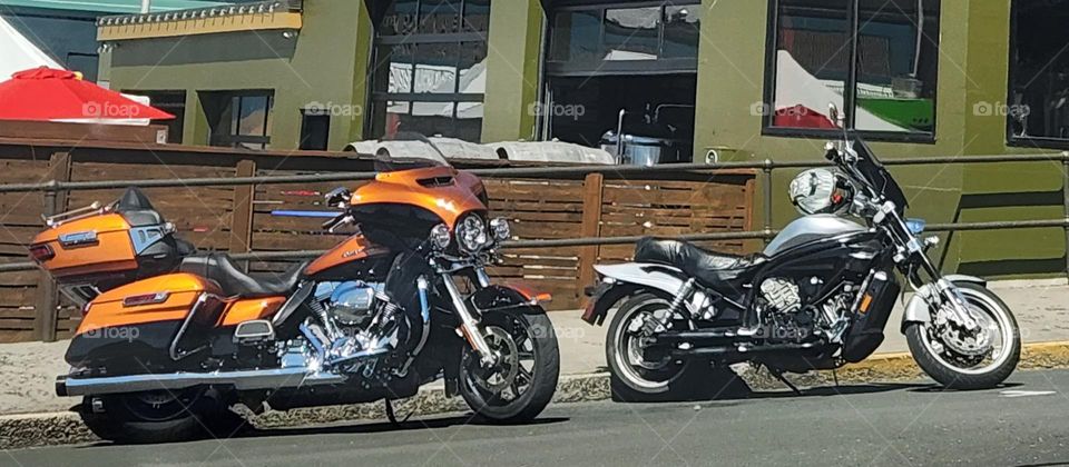 two motorcycles parked outside of a business in a coastal Oregon town