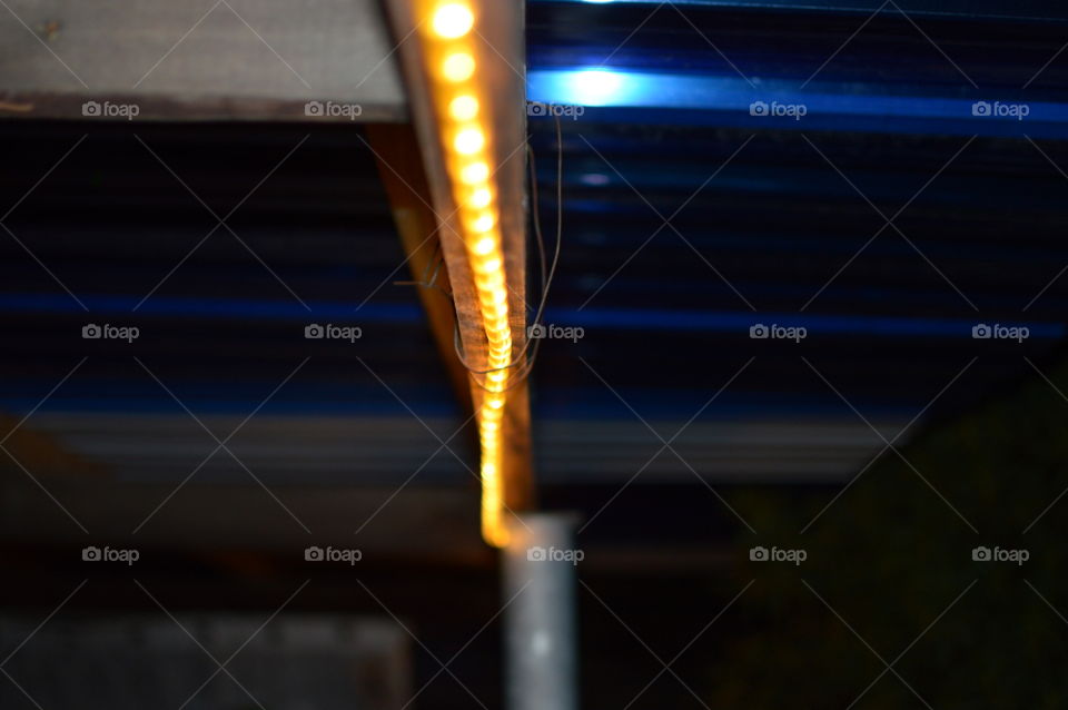 A yellow band of neon rope lights fading in the distance