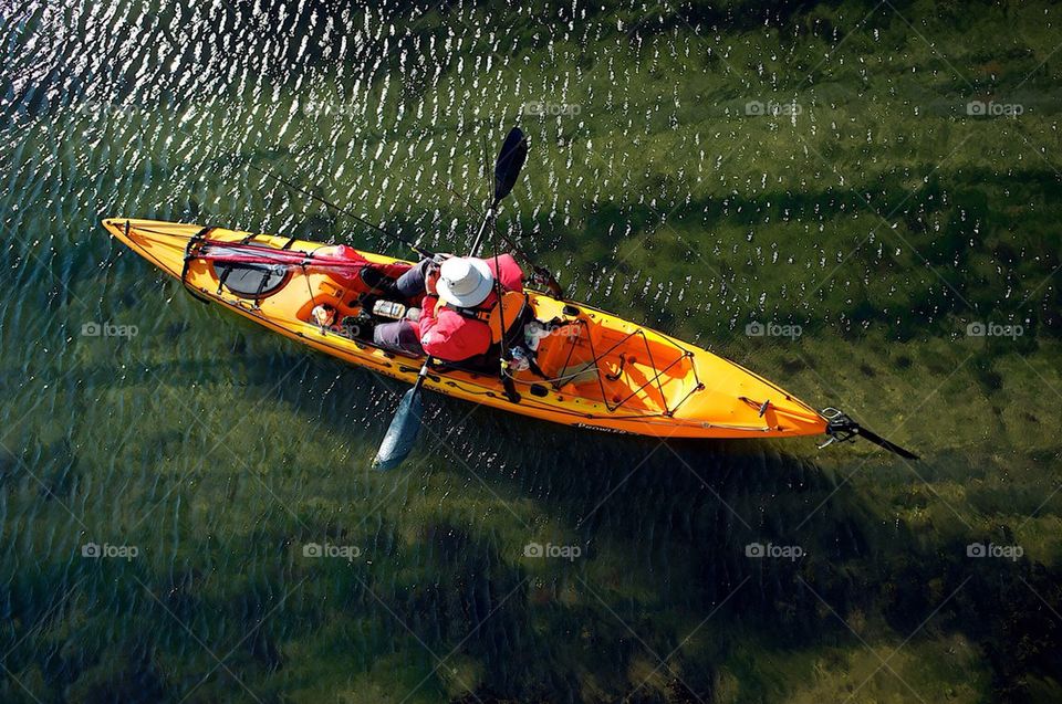 A man sets out to sea in a kayak.