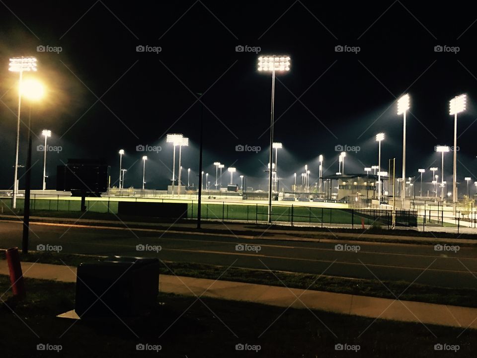 Giant baseball facility at night.