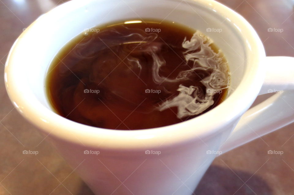 coffee in mug with swirling creamer
