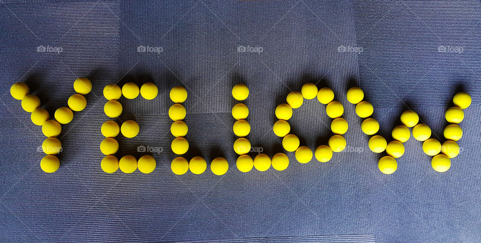 Yellow. word yellow written with balls