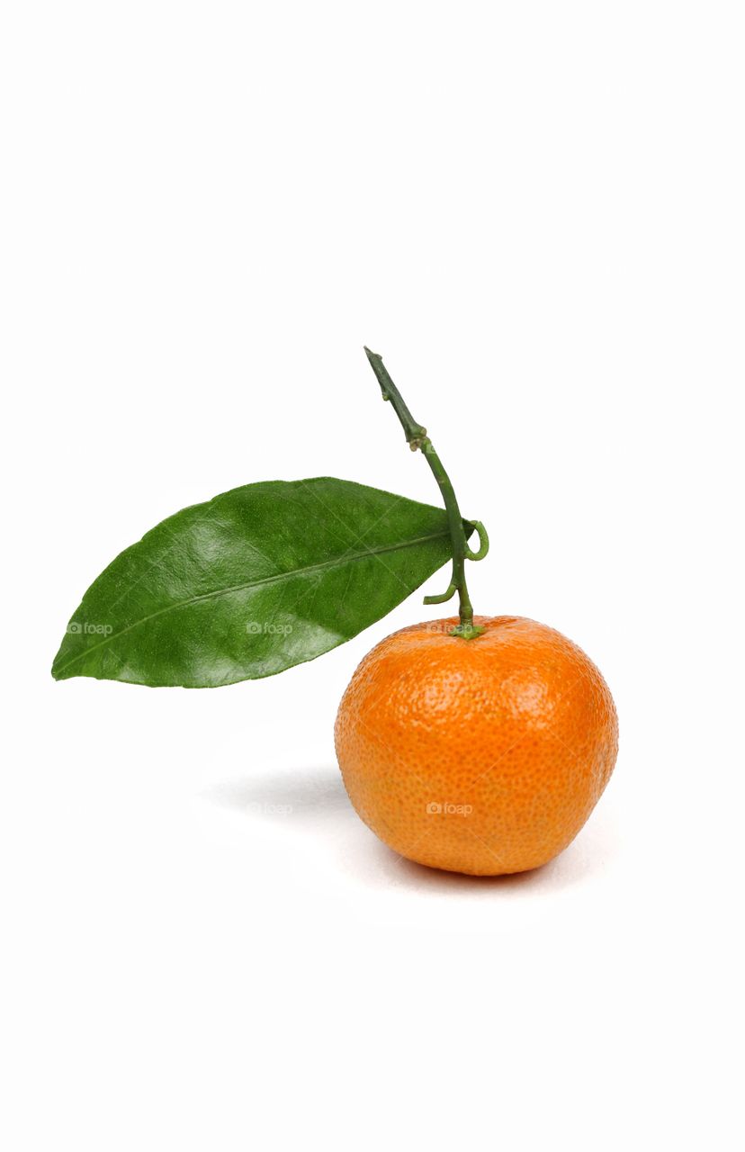 Orange mandarin with leaf on a white background