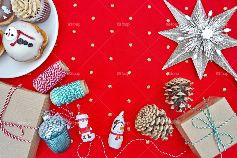 Christmas decor on red polka dots table cloth, santa and snowmen chocolate , Christmas theme doughnuts