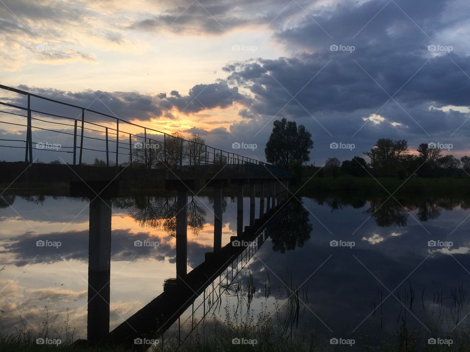 Sunset over lake with bridge