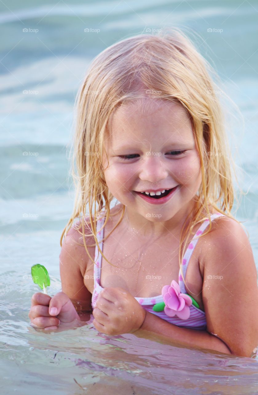 Cute girl swimming in pool