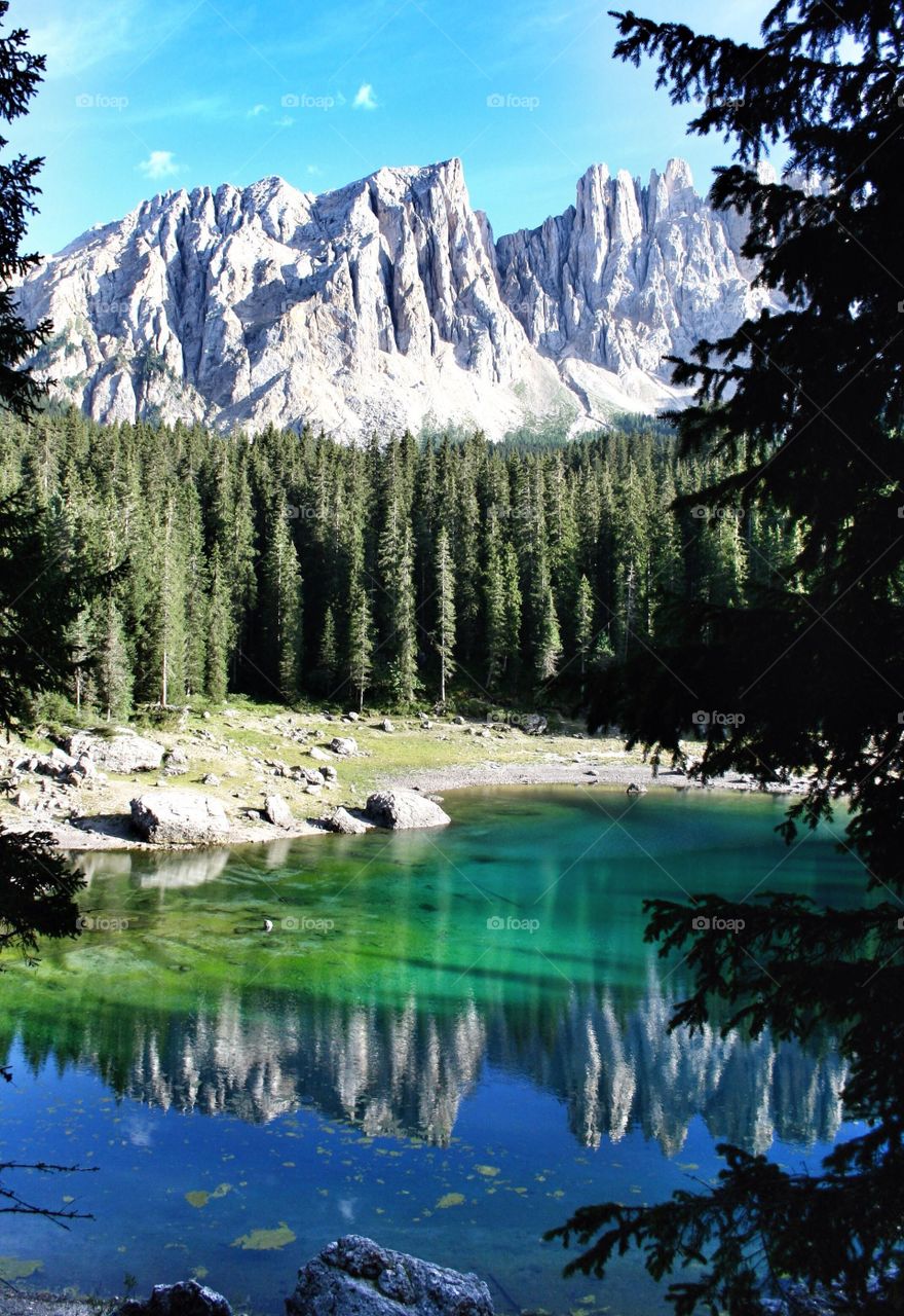 Reflection of mountain range on lake carezza