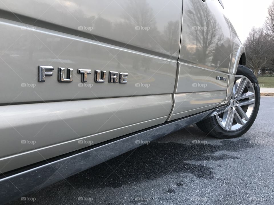 SUV with the word future in chrome lettering on the side. 
